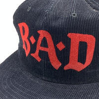 B.A.D ビッグオーディオダイナマイト プリント コーデュロイ 6パネルキャップ ブラック スナップバック オールド YUPOONG 福生店