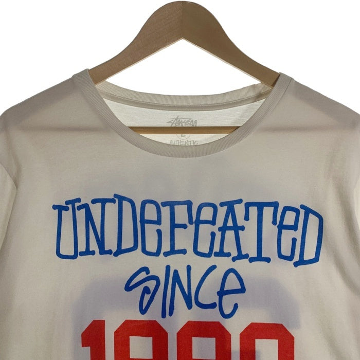 STUSSY ステューシー UNDEFEATED since 1980 アンディフィーテッド プリントTシャツ ホワイト Size L 福生店